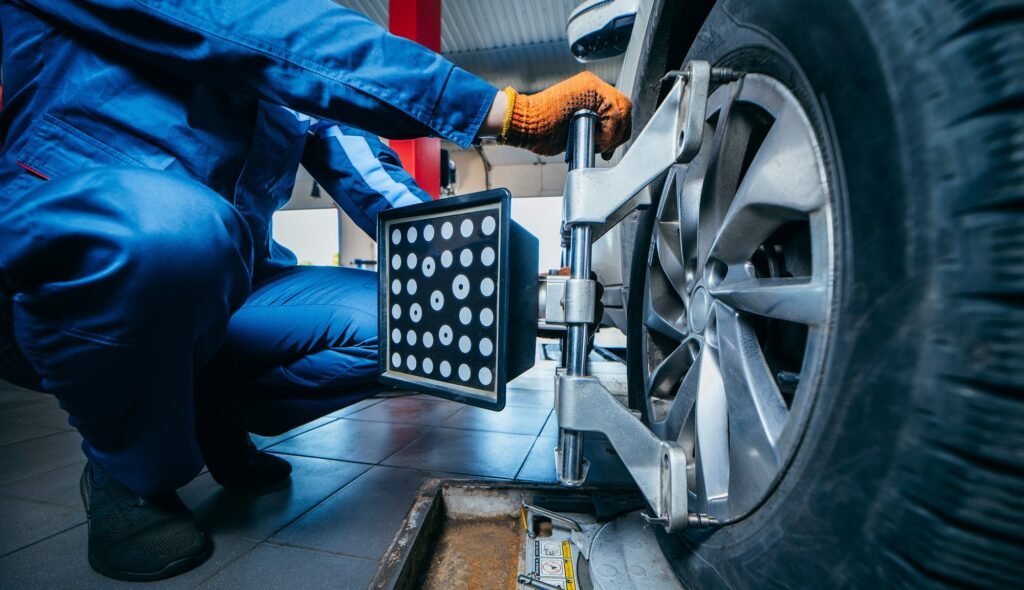 auto mechanic installing sensor during suspension adjustment and automobile wheel alignment work at repair service station. close up auto mechanic installing sensor during suspension adjustment and automobile wheel alignment work at repair service station. close up